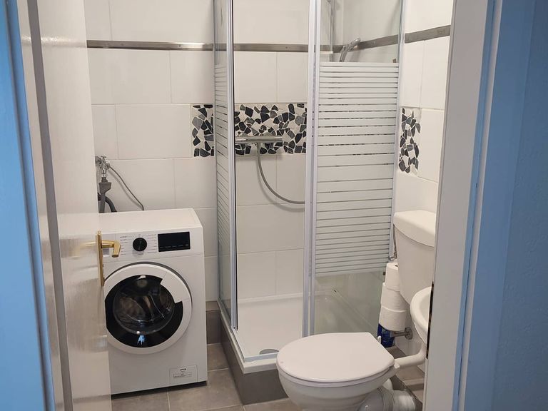 Badezimmer mit Dusche, WC und Waschmaschine